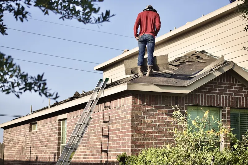 Professional roofer working on a residential roof in North Central